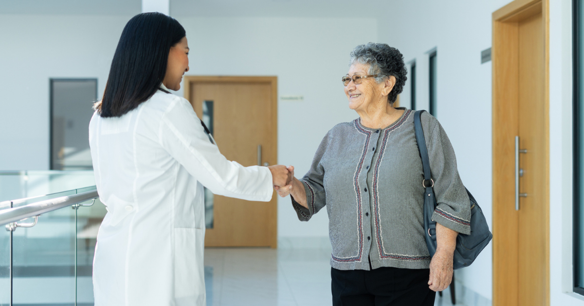 Older woman shaking hands with doctor