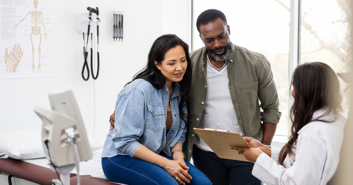 Man and woman talking to doctor