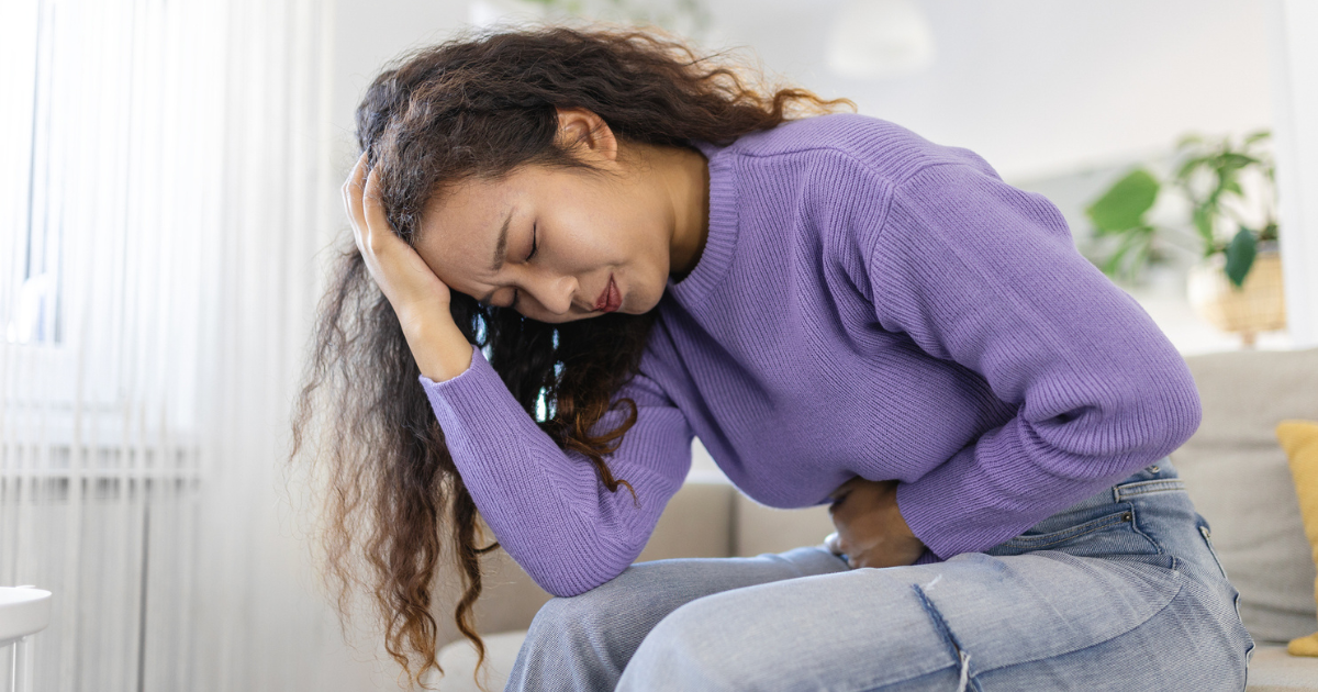 Woman holding stomach in pain
