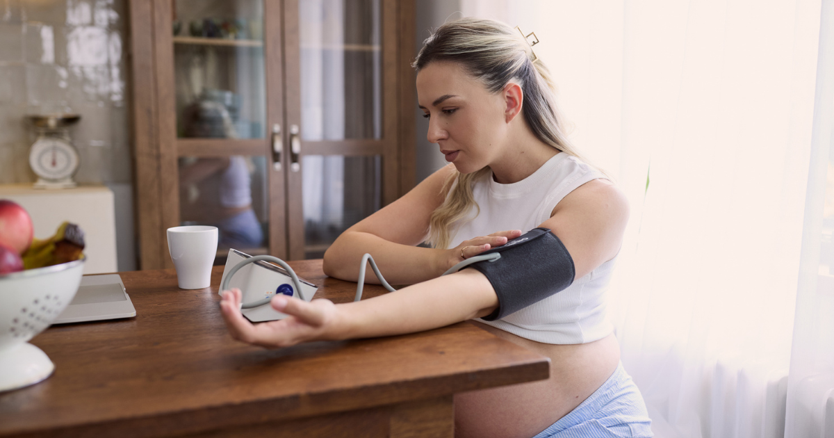 Pregnant woman taking her blood pressure