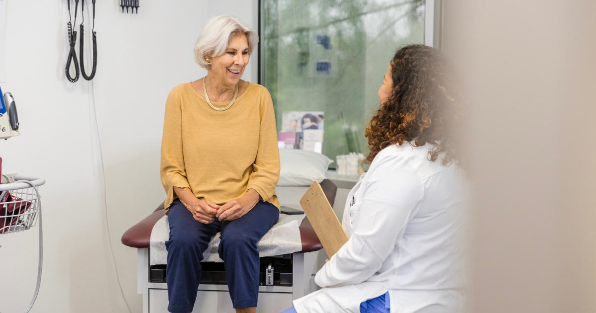 Older woman talking to doctor