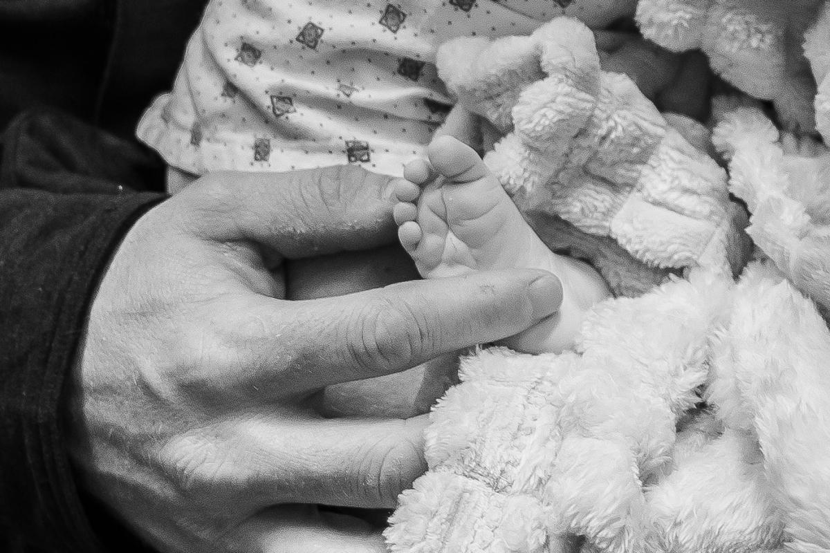 Nick Williams holding daughter Parker's foot