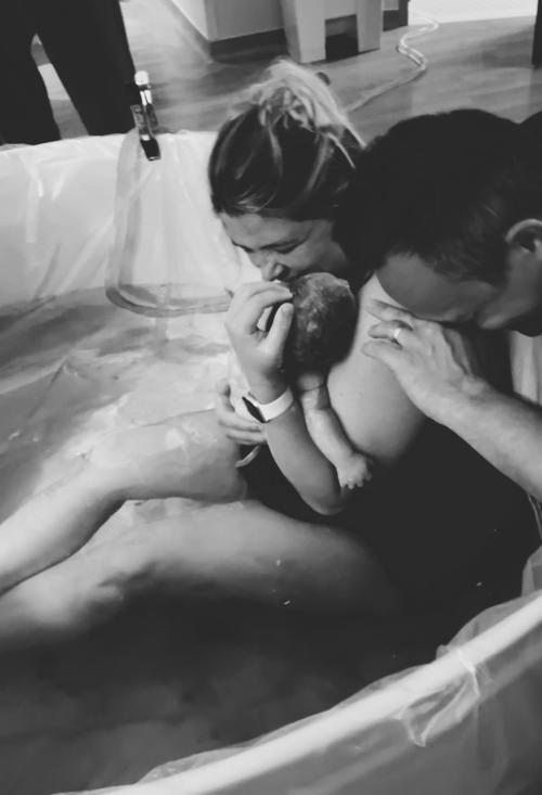 Jessica Schultze, husband, and daughter Margaret in water birth pool