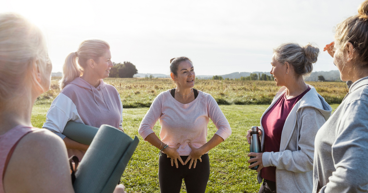 Group of women holding yoga mats