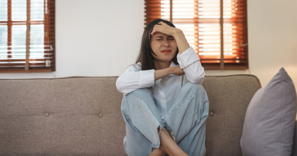 Upset woman sitting on couch
