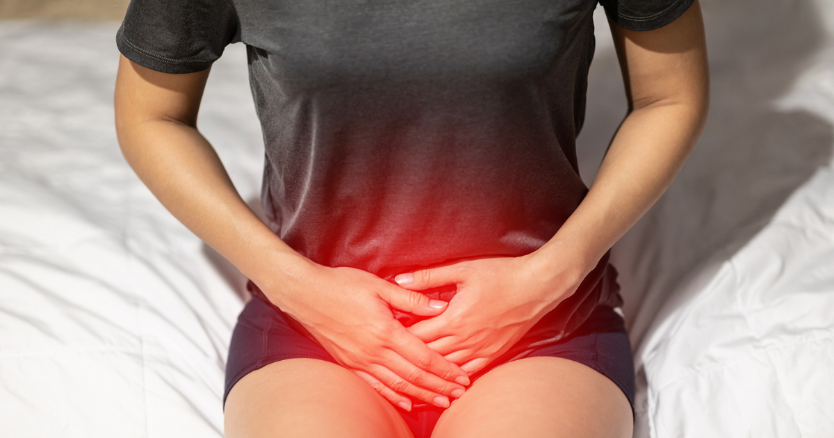 Close up of woman holding pelvis in pain