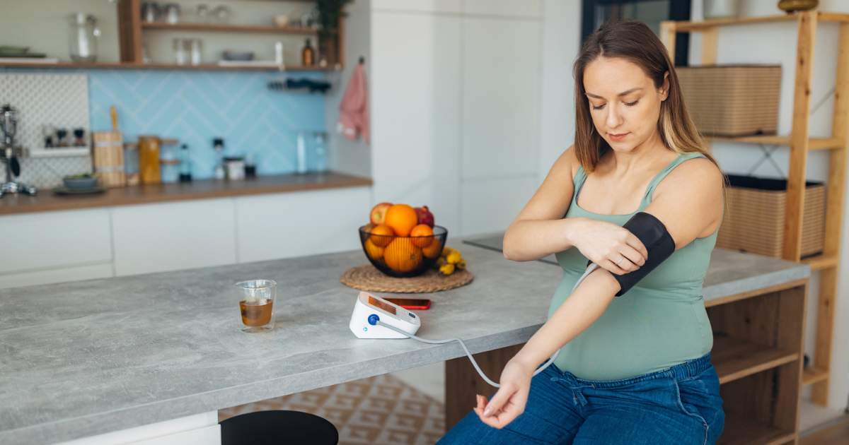 Pregnant woman checking her blood pressure