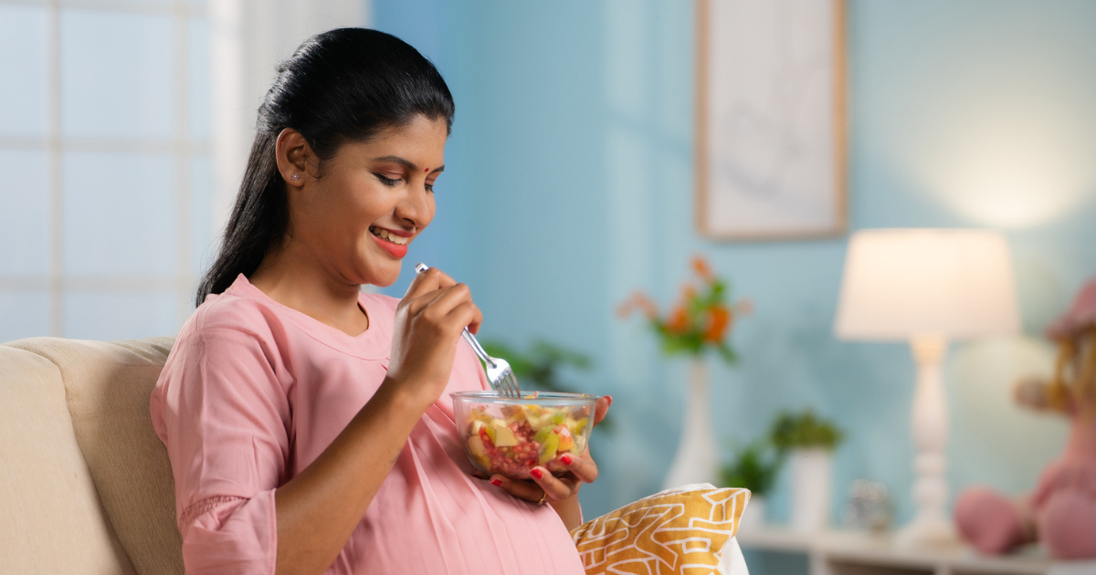 Pregnant woman eating fruit