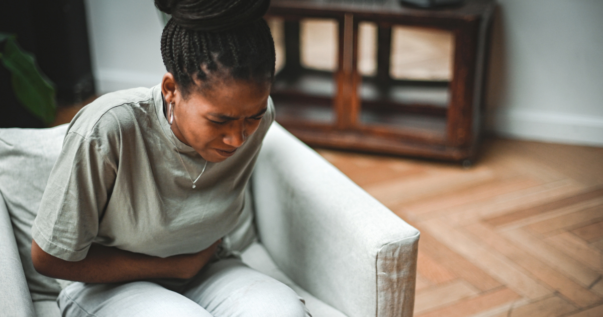 Woman holding her stomach in pain