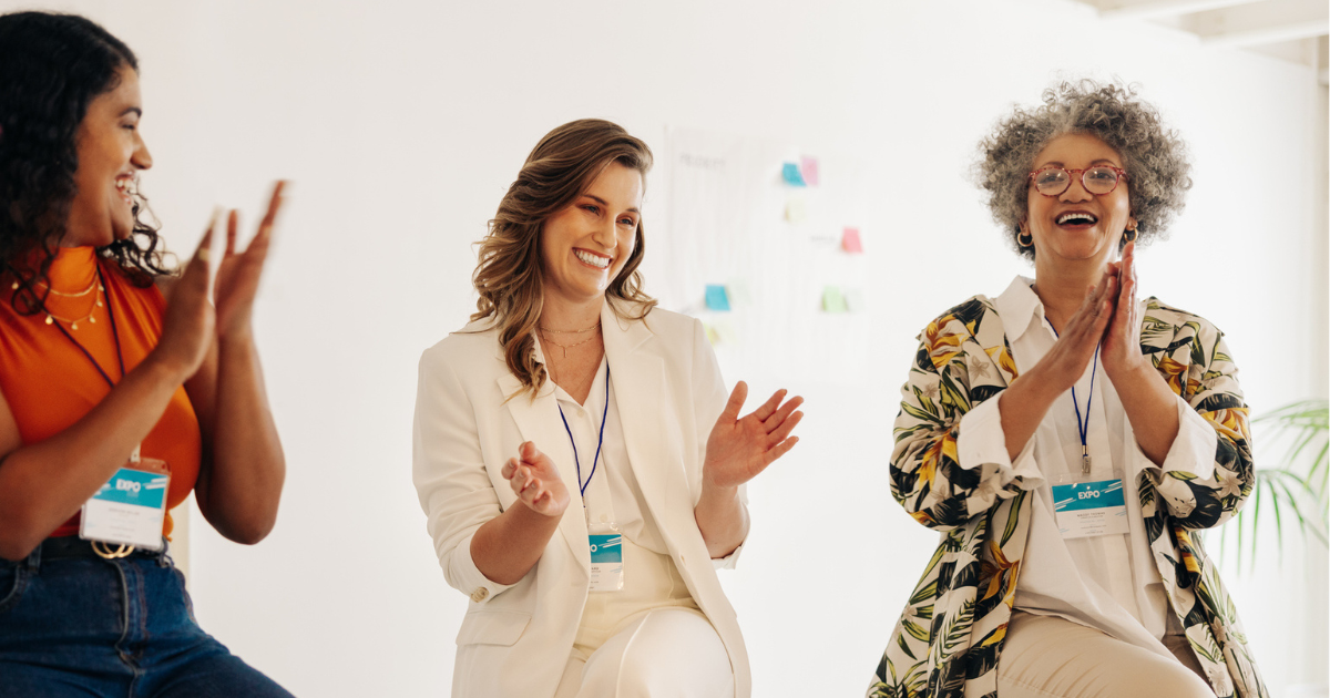 Three women clapping