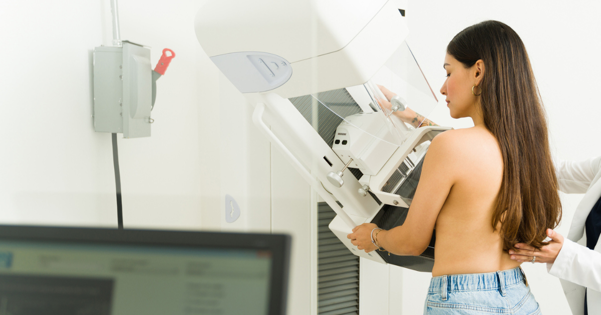 Doctor adjusting woman for a mammogram