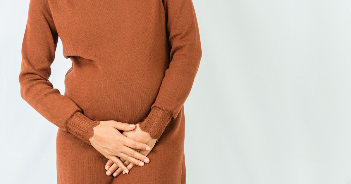 Woman holding her bladder