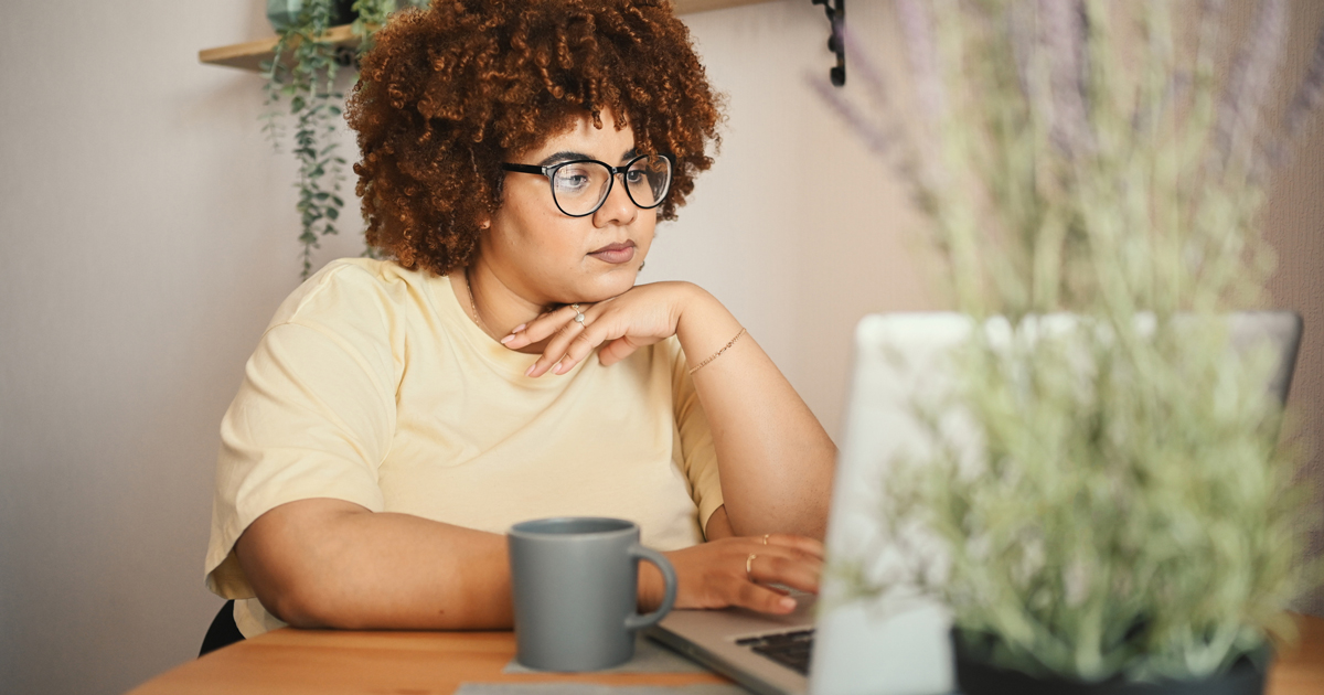 Woman researching at a computer.