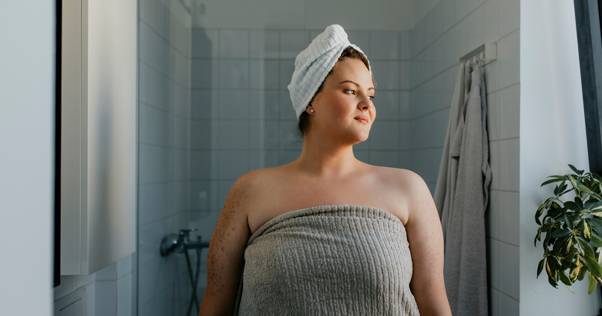 Woman wrapped in a towel coming out of the shower