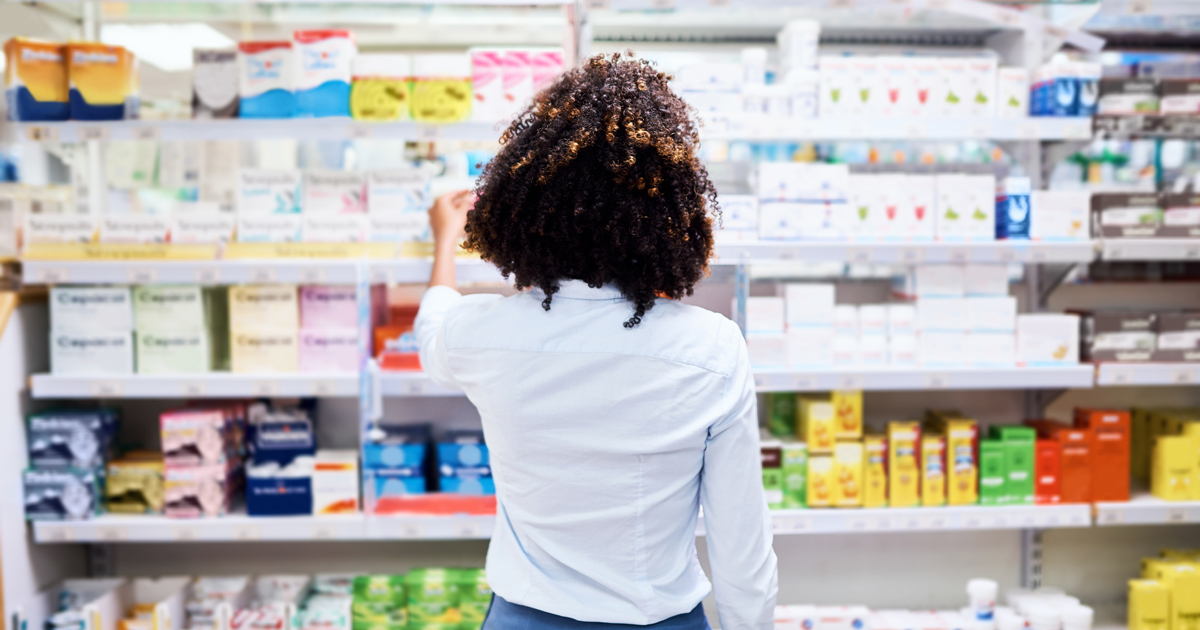 Woman shopping in pharmacy aisle