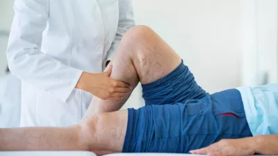 Image of legs being looked at by a doctor.