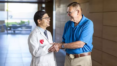 Vijaya Bhatt, MBBS, hematologist and medical oncologist, and Steve Waller, patient, visit following a check-up more than two years out from receiving a clean bill of after receiving treatment for leukemia.