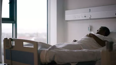 Elderly man in a hospital bed