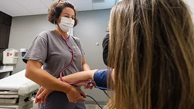A nurse taking a patient's blood pressure.