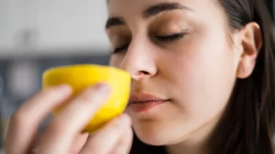 picture of a woman smelling a lemon