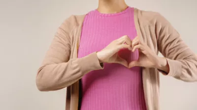 picture of a woman making a heart with her hands