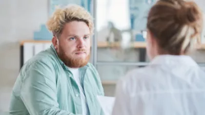 Man sitting, speaking to his doctor
