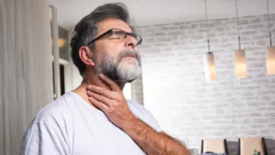 Man holding his throat