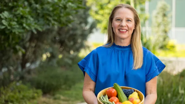 Rebecca Beaudoin, registered dietitian holding a basket of vegetables
