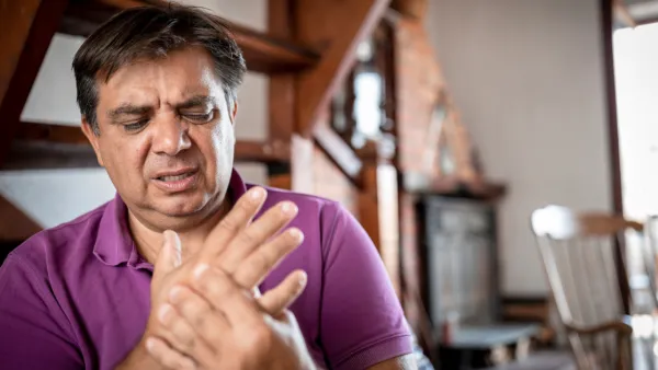Man holding his hand in pain