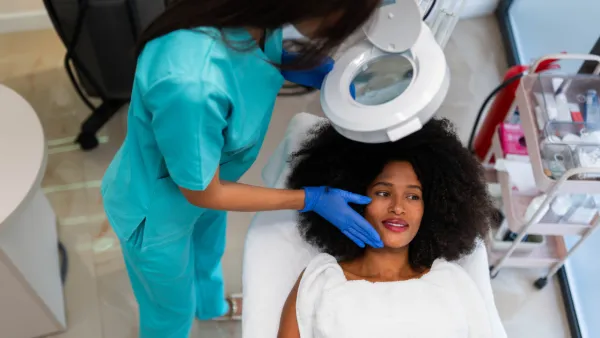 Provider using magnifier to evaluate patient's scalp
