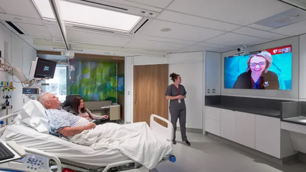 A remote nurse working with a bedside care team in the Innovation Design Unit