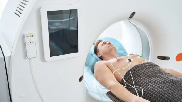 Man lying in CT machine