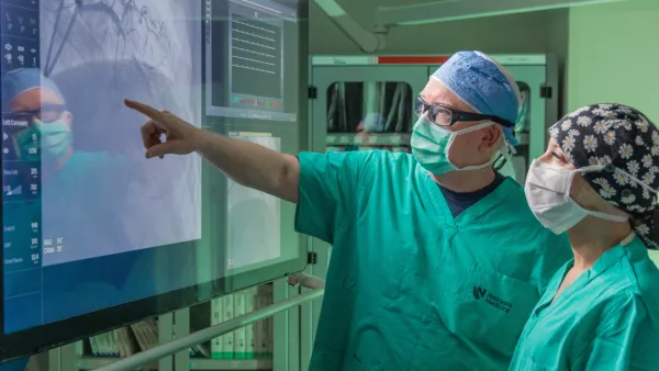 Dr. O'Leary pointing at cardiovascular image on screen with Kara Kendra on right