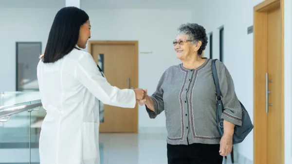 Older woman shaking hands with doctor