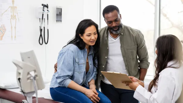 Man and woman talking to doctor