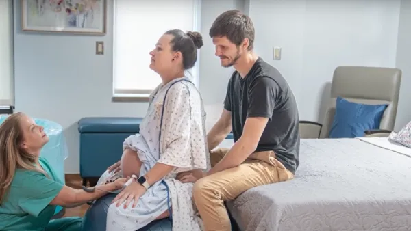 Pregnant woman and partner in Holistic Birth Place with midwife