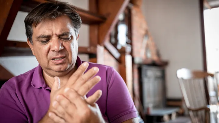 Man holding his hand in pain
