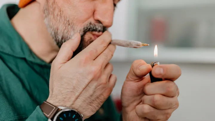 Close up of man smoking marijuana