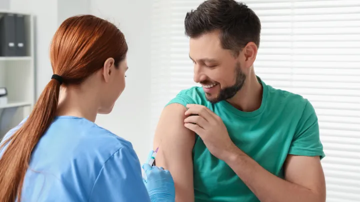 Nurse giving man a shot in arm