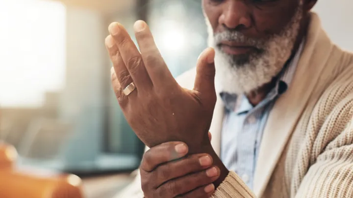 Close up of man holding wrist