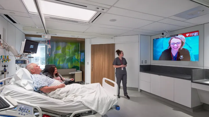 A remote nurse working with a bedside care team in the Innovation Design Unit