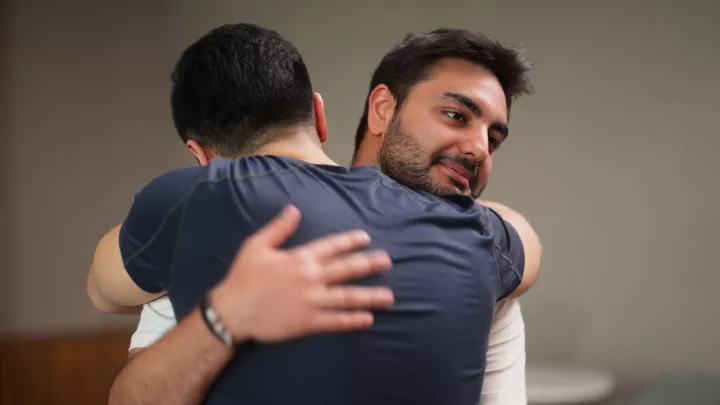 Two men hugging