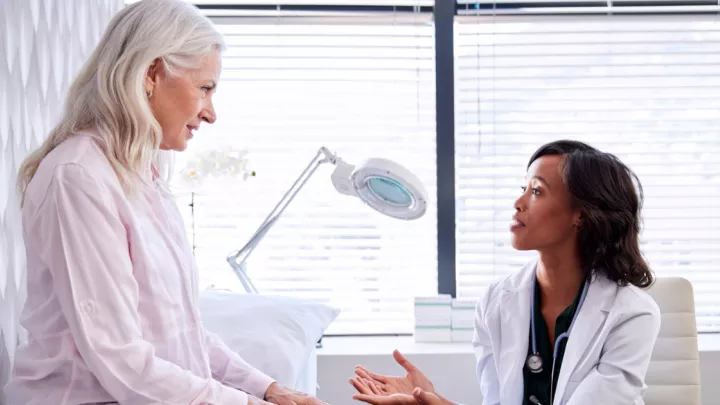 A picture of an older woman talking to her doctor