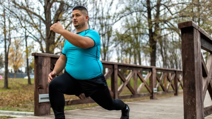 A picture of a man exercising on a bridge