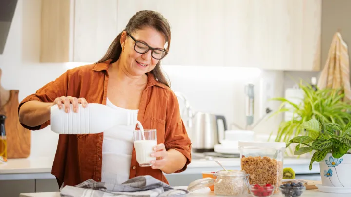 Woman pouring milk in a glass