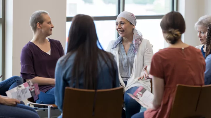 Woman with a headscarf talking in a support group