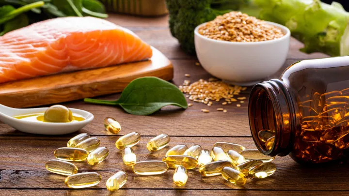 Fish oil pills on table with foods high in omega-3's