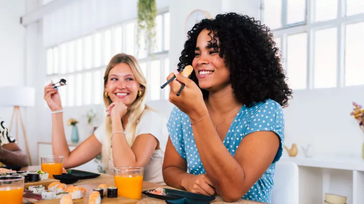 Two women eating sushi