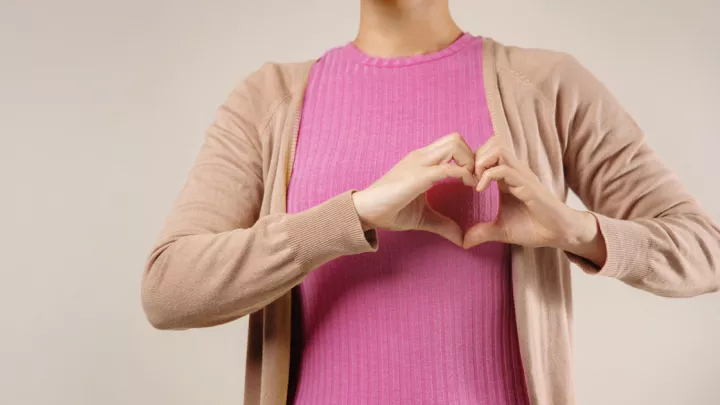 Woman making a heart with her hands in front of her chest