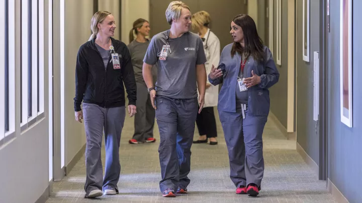 Three nurses have a conversation